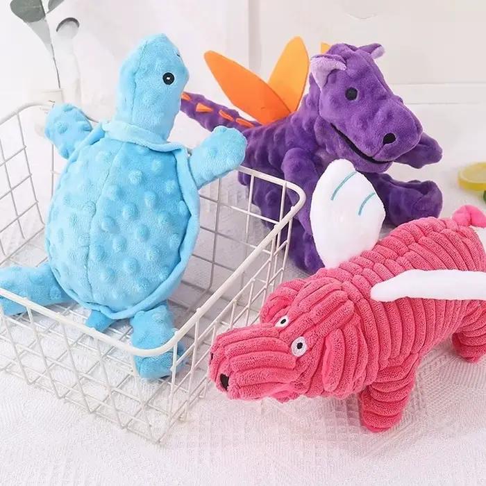 Jouet pour chien en peluche à texture pointillée, en forme de dragon de dessin animé, couineur, résistant aux morsures, avec design de membres, pour soulager le stress et favoriser le jeu interactif.