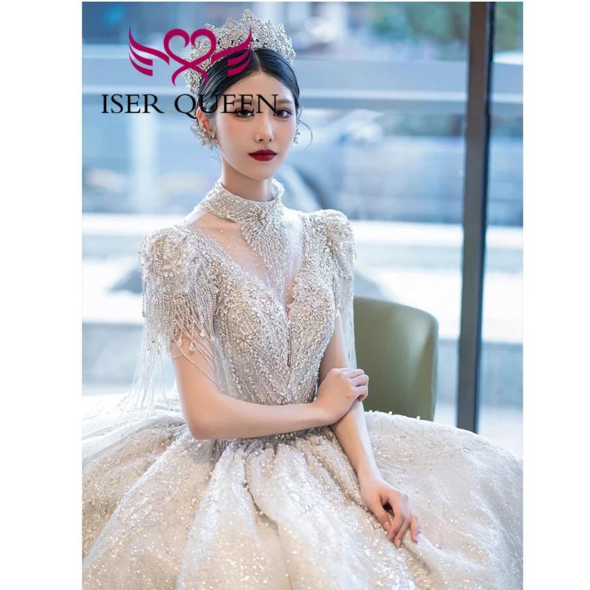 Robe de mariée de luxe personnalisée, nouvelle tendance 2026, pour femme, col montant, manches à franges, perles lourdes, robes de mariée scintillantes WX0474